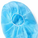 Close-up of non-woven disposable astronaut hood cap material and elastic face opening