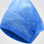 Close-up of blue non-woven disposable nurse cap material and elastic edge