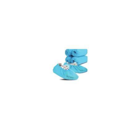 Blue disposable medical shoe covers in front with three rolled blue gowns stacked behind them, arranged for hygienic barrier use.